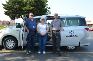 Three people stand outside of a C-Tran vanpool