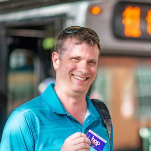 steve with his hop card in front of bus