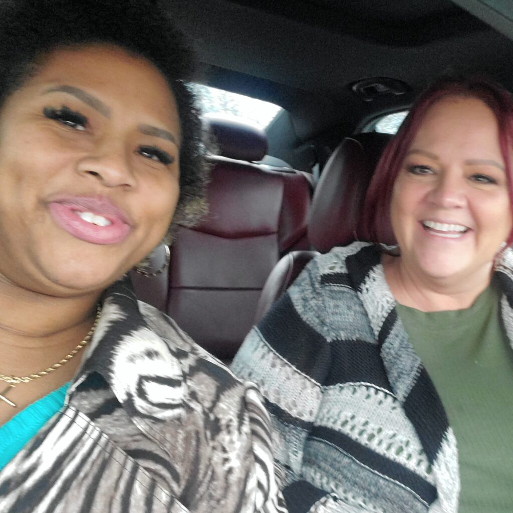 Two women taking a selfie as they drive carpool to work together